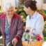 A caregiver shops for groceries with an older adult, representing shopping for a diabetes-friendly diet.