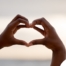 2 hands making a heart represent self-care, a vital concept to appreciate as a caregiver.