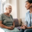 A caregiver sits and spends time with a client, representing how non-medical home care can benefit older loved ones.