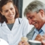 A woman smiles while with clients showing how you can enjoy senior caregiver jobs.