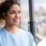 A woman smiles while looking ahead hopefully, showing the positive outlook that planning for a home care career can bring.