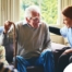A woman has a good time with her older clients, representing the kind of personal skills needed to be a good caregiver.