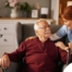 A caregiver helping a woman with a walker make her senior home safer.