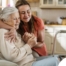 Caregiver supporting an elderly woman in the transition to senior home care