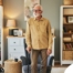 Exploring fall prevention for seniors — an elderly man stands in a safely arranged room.
