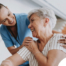 A female caregiver helping an older woman with stroke recovery at home.